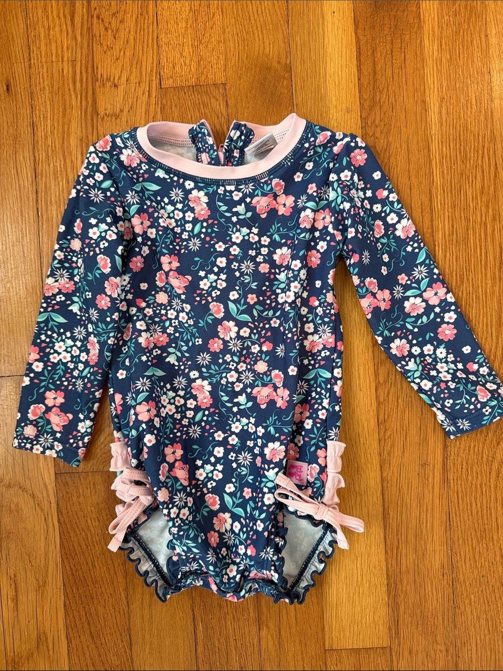 Ruffle Butts Navy Floral Long-Sleeve One-Piece Swimsuit with Pink Accents